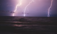 Thunder rolling in at night at a beach during the summer
