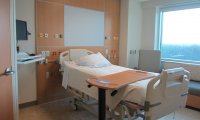 sitting at the bedside of someone unconscious in the hospital