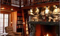 Sitting in a cozy library next to a fireplace
